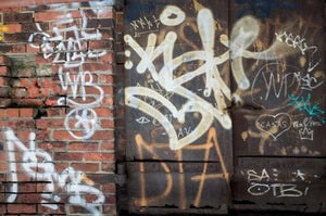 graffiti on gritty brick wall and metal door