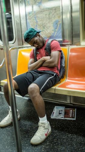 student sleeping on subway train in summer - kid asleep in NYC