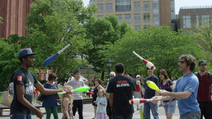jugglers in Washington Square Park in summer juggling bowling pins slow motion 4K