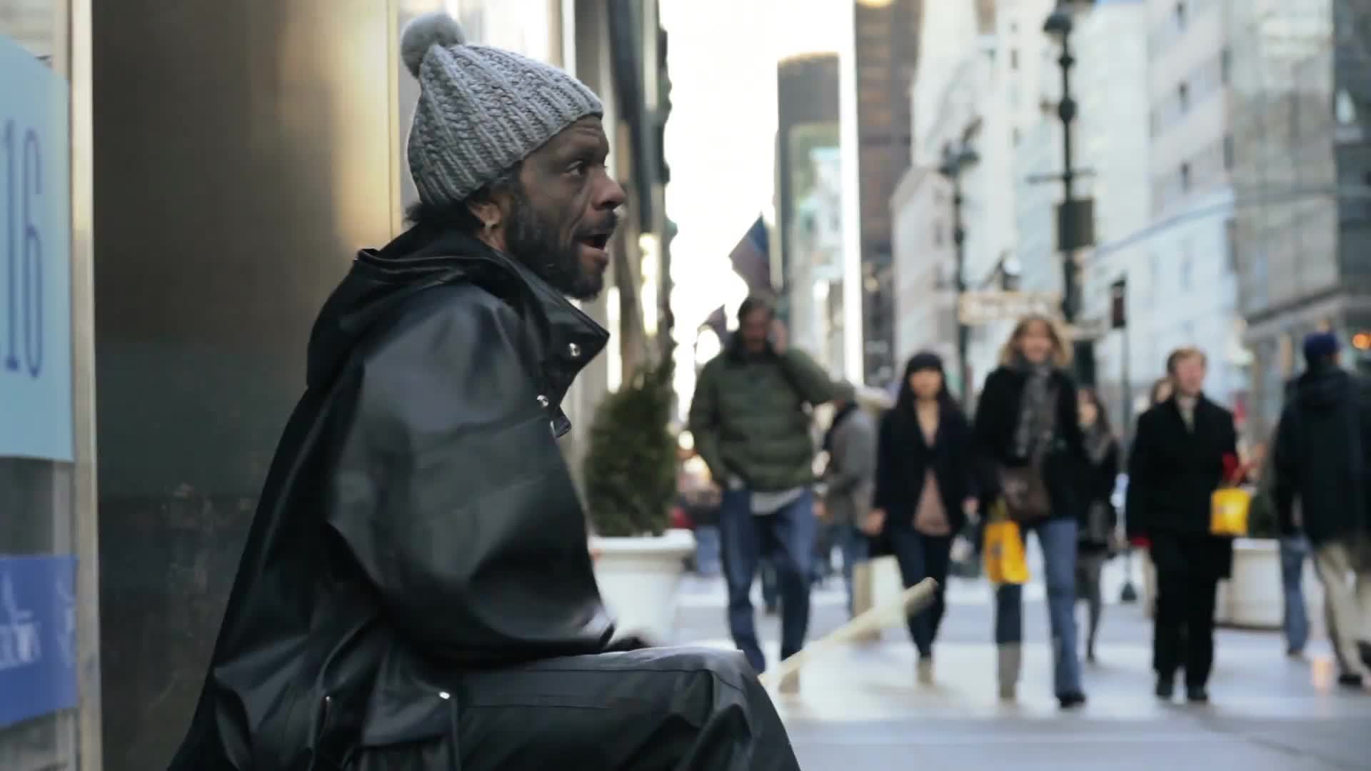 street performer drumming on buckets, drummer on cold winter day Midtown Manhattan