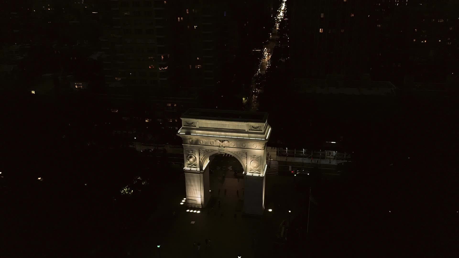 circling arch in Washington Square Park at night in New York City NYC