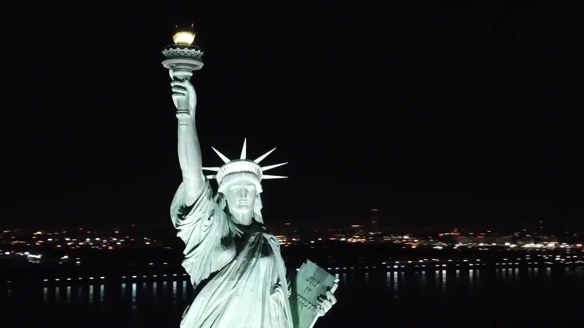 Statue of Liberty aerial circling at night in 1080
