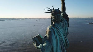 Statue of Liberty rear view looking out onto sea in New York City