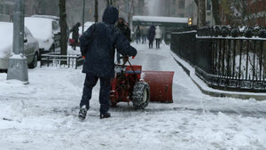 man plowing snow with plow in storm - snowing blizzard in Manhattan winter 4K