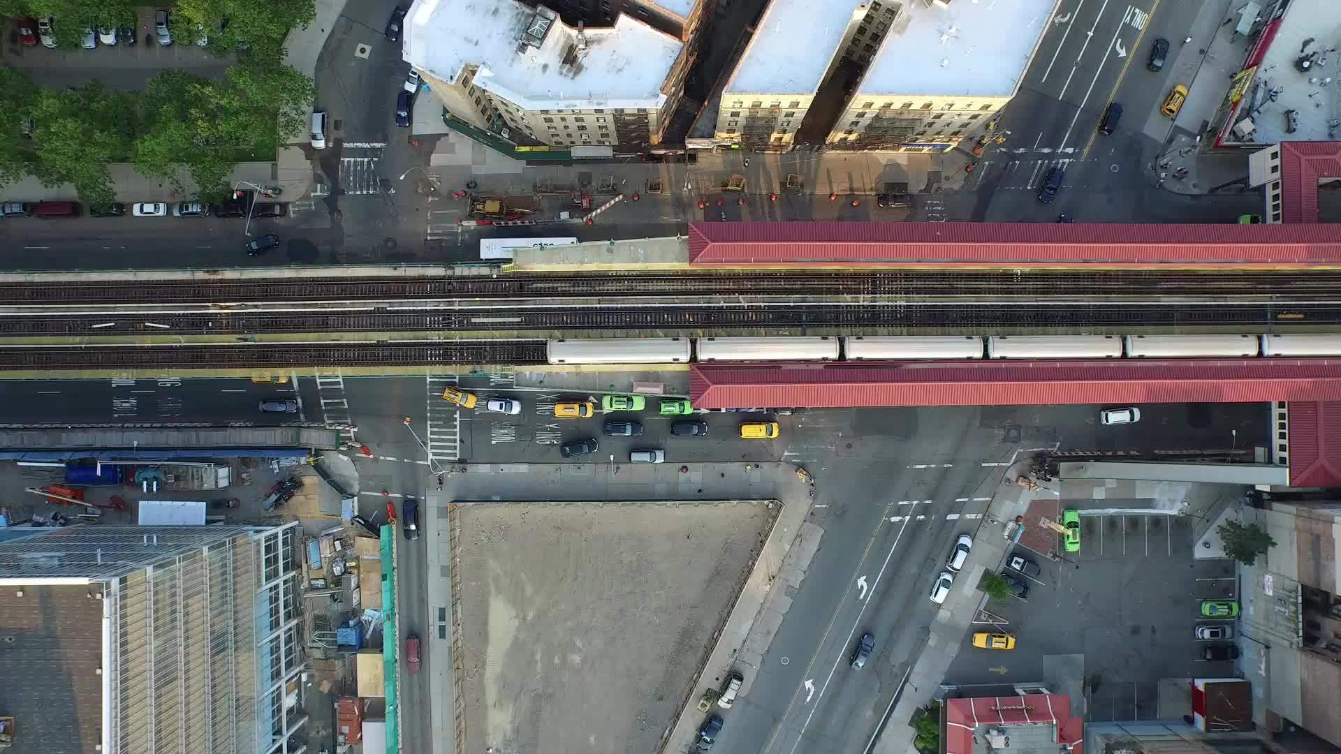 aerial of Harlem elevated subway track - looking down on 1 train Uptown NYC