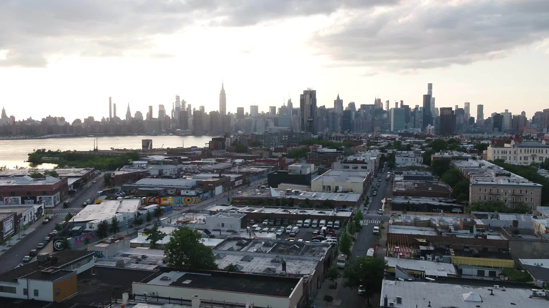 aerial over Greenpoint Brooklyn moving toward Manhattan skyline NYC
