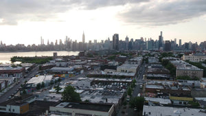 aerial over Greenpoint Brooklyn moving toward Manhattan skyline NYC