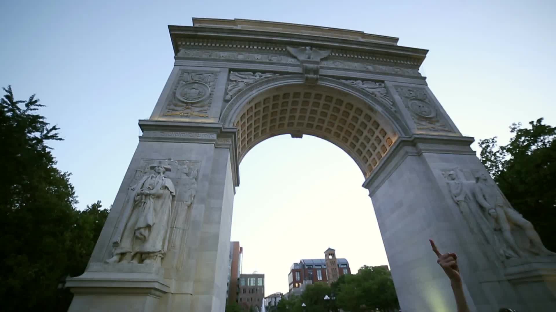 man arguing with pro-Palestinian protestor under arch in Washington Square Park in NYC