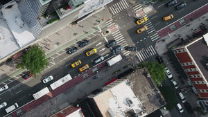 overhead aerial diagonal cars driving in Midtown Manhattan traffic NYC