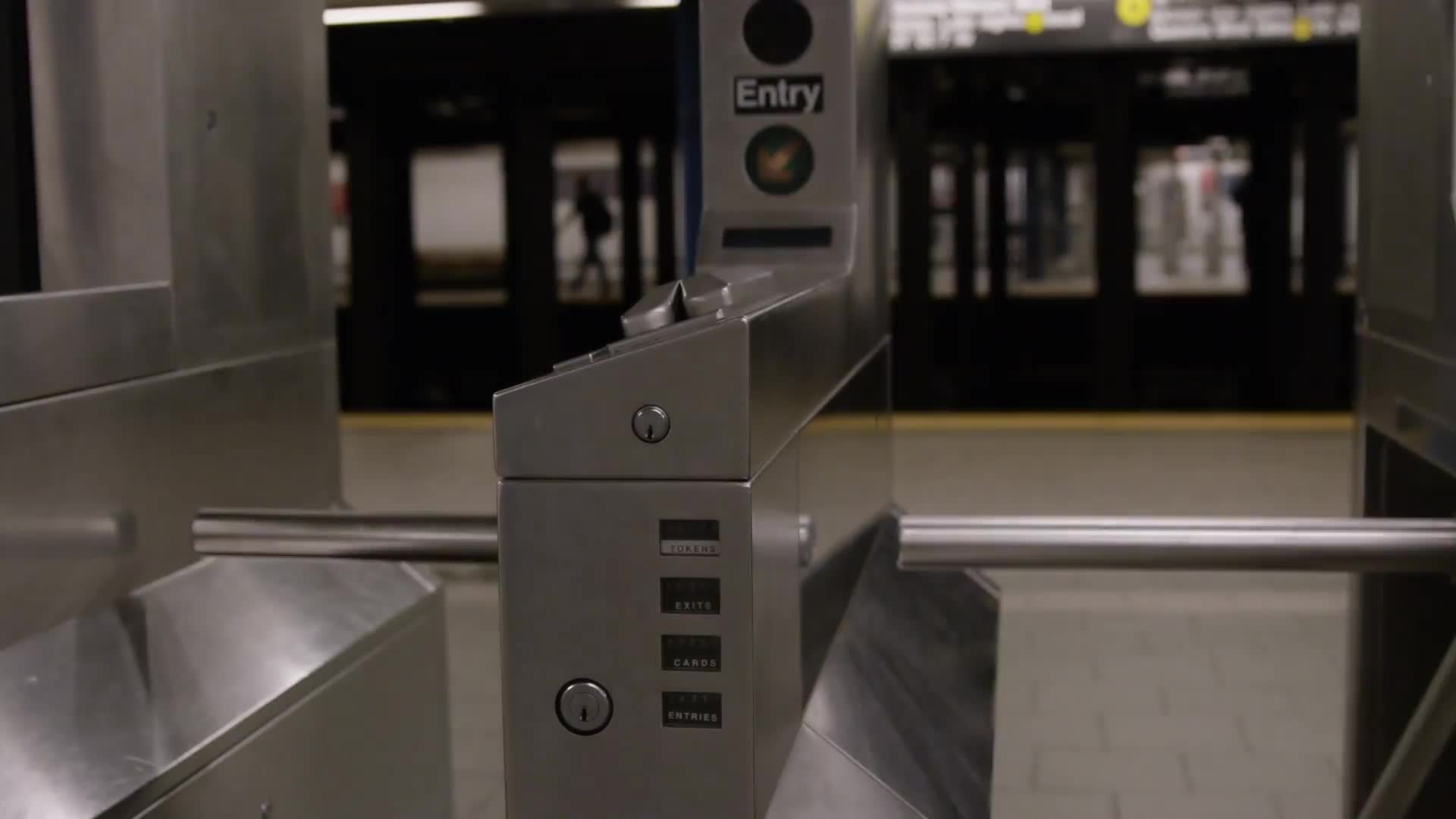 turnstiles in empty subway station and platform - tracking shot