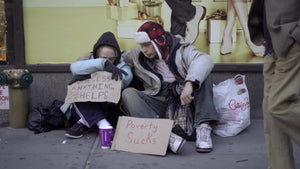 homeless couple struggling with help signs, poverty sucks for street people in New York City NYC