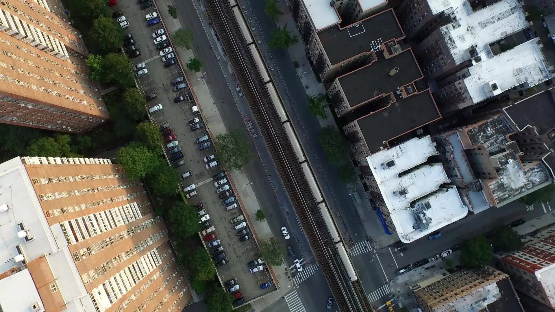 aerial over 1 train elevated track and red brick housing projects in Harlem NYC