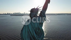 Statue of Liberty back in New York Harbor - aerial over water in NYC