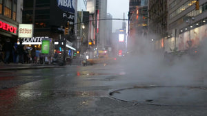 steaming manhole on street with steam coming out in Midtown Manhattan - 34th Street near Times Square