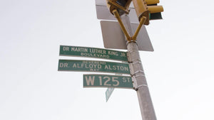 125th street Martin Luther King Jr Blvd sign in Harlem Uptown Manhattan close-up 4K NYC