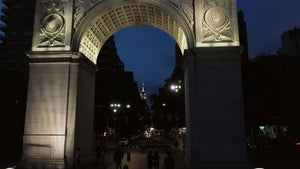 rising shot of Empire State Building from Washington Square Park arch in NYC