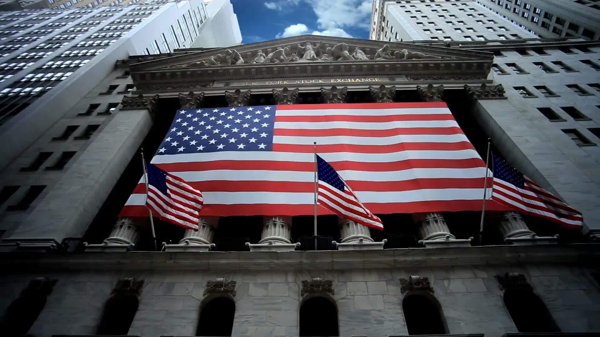 New York Stock Exchange Time-lapse with American flags on Wall Street in Downtown Manhattan New York City NYC in 1080 HD