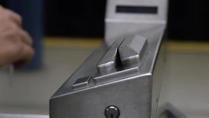 close-up on hand swiping Metro Card at turnstile in subway station in NYC