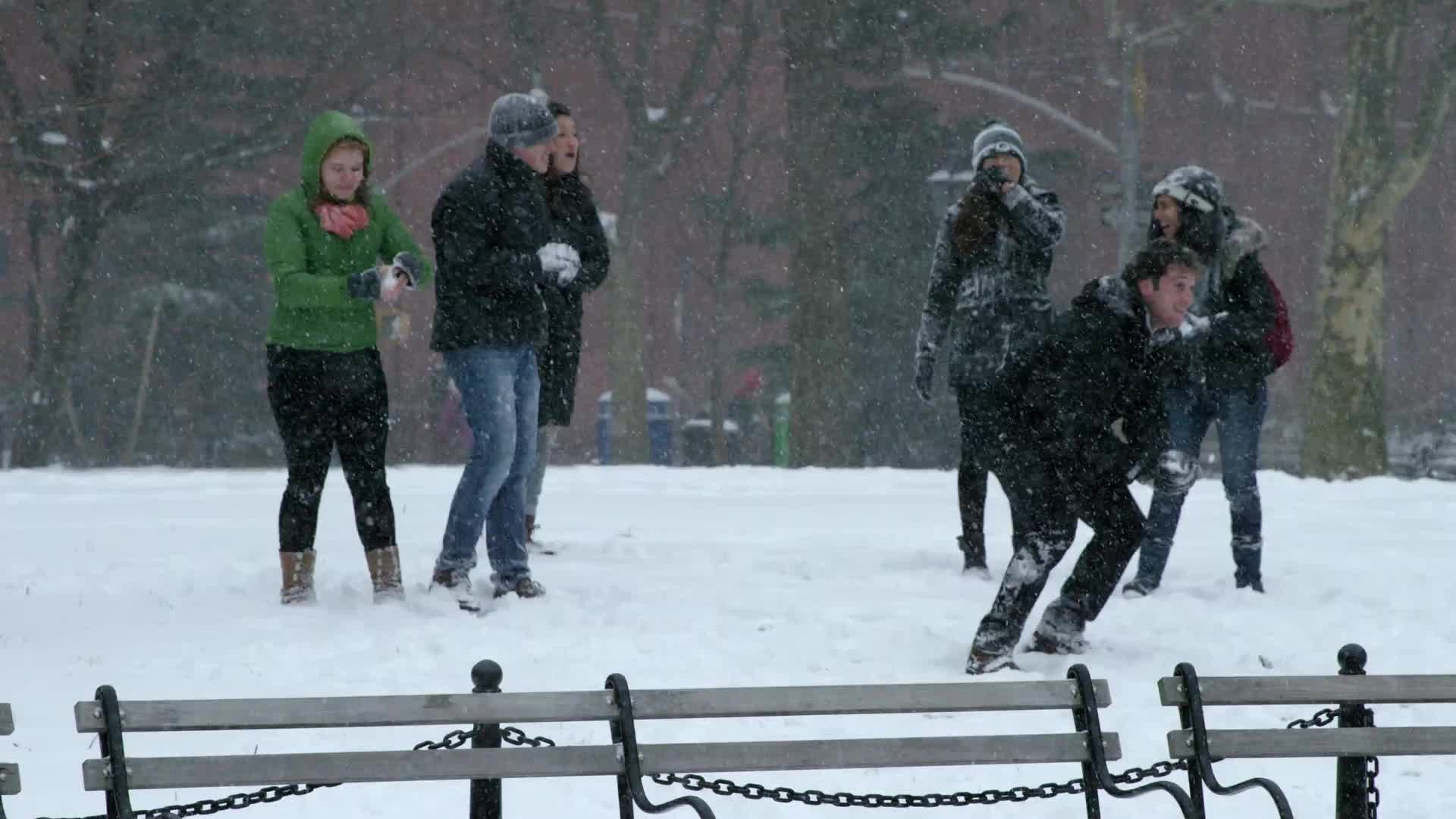 girl throwing snowball in winter blizzard Washington Square Park snowing slow motion 4K
