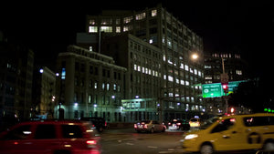 taxicabs at night driving on 7th Ave Varick Street downtown at busy intersection before Holland Tunnel