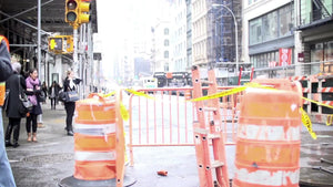 construction worker holding traffic sign on street bright sunny day Broadway Downtown Manhattan NYC