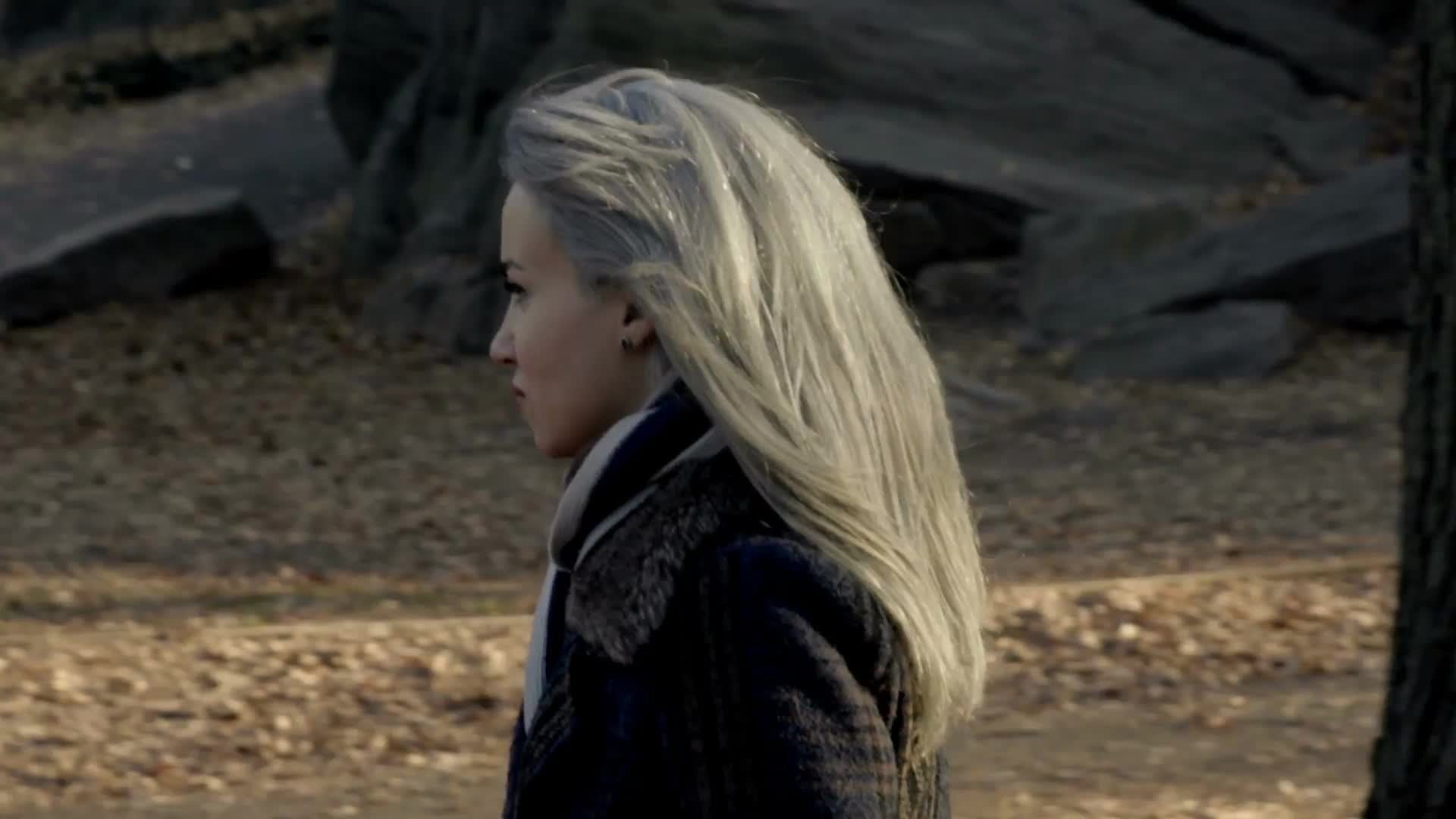 attractive woman with platinum colored hair walking in Central Park on chilly fall day in slow motion, autumn in NYC