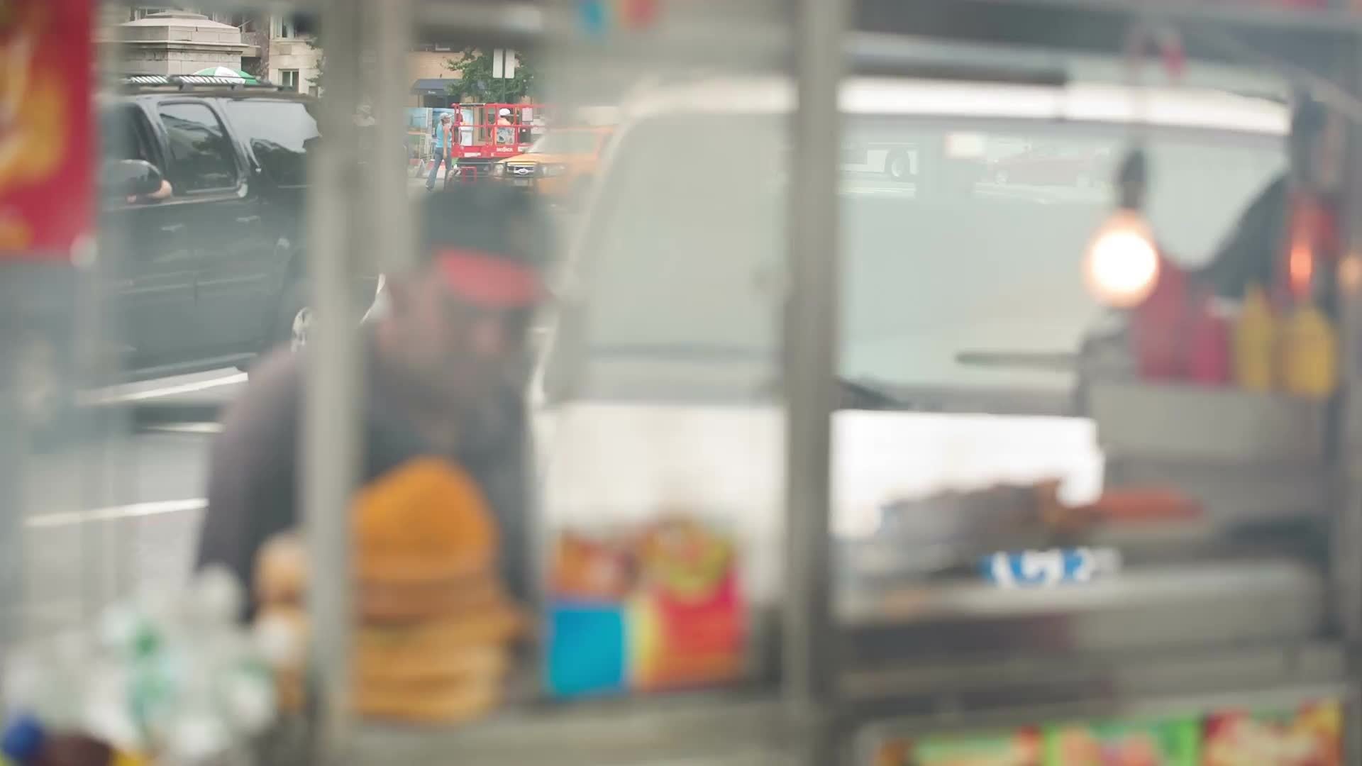 smoky food truck street hot dog vendor in Columbus Circle - man making shish kebab