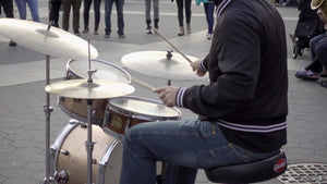 drummer playing music with band musicians - drumming in Washington Square Park on cold fall day - Manhattan New York City NYC