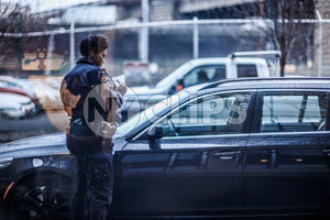 police officer writing parking ticket on street - female cop