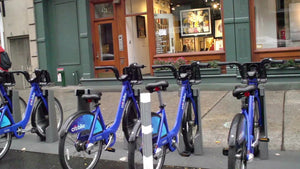 driving by CitiBike docking station on street - blue bicycles parked