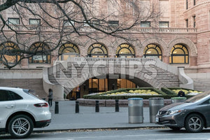 American Museum of Natural History side planetarium entrance with cars parked and recycle cans
