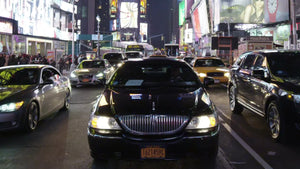 Uber car driving through Times Square at night in New York City