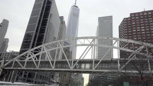 driving on West Side Highway under Tribeca Bridge with Freedom Tower overhead in Lower Manhattan NYC