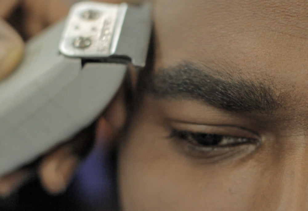 Still from O Da Addic music video barber shop shot