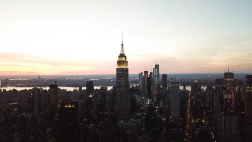 Empire State Building at sunset from high aerial helicopter view in Manhattan New York City NYC