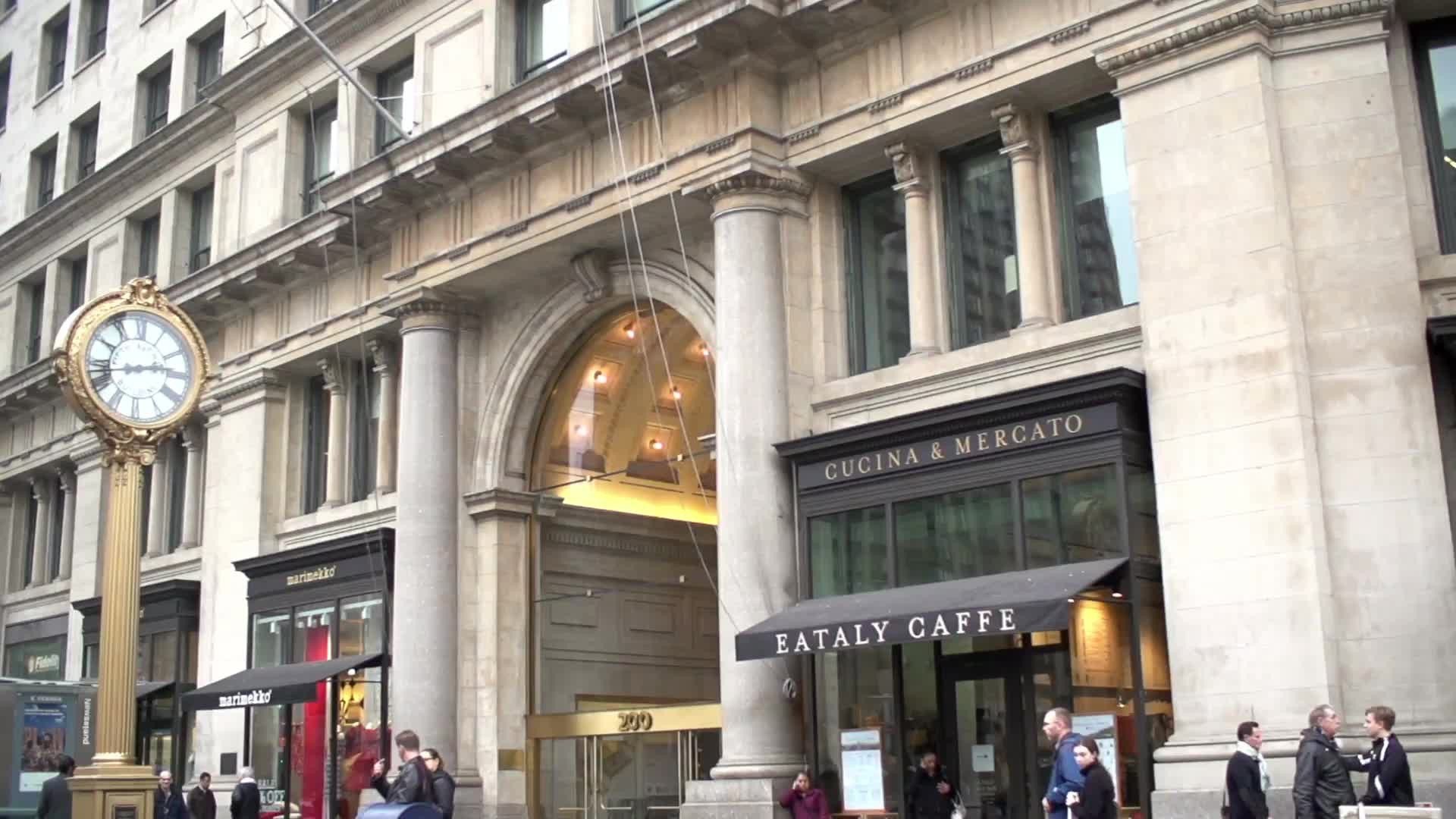 Eataly Caffe and famous 5th Ave clock in slow motion from moving vehicle in Manhattan NYC