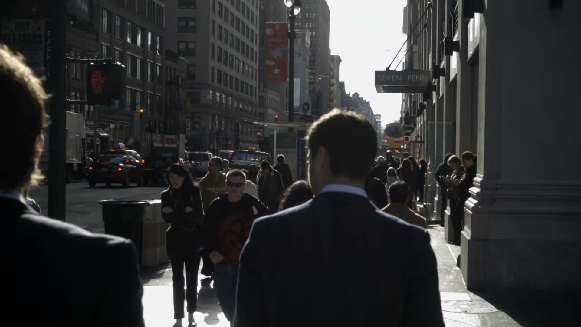 men in suits walking in slow motion on Park Ave in Midtown Manhattan on bright sunny day in NYC