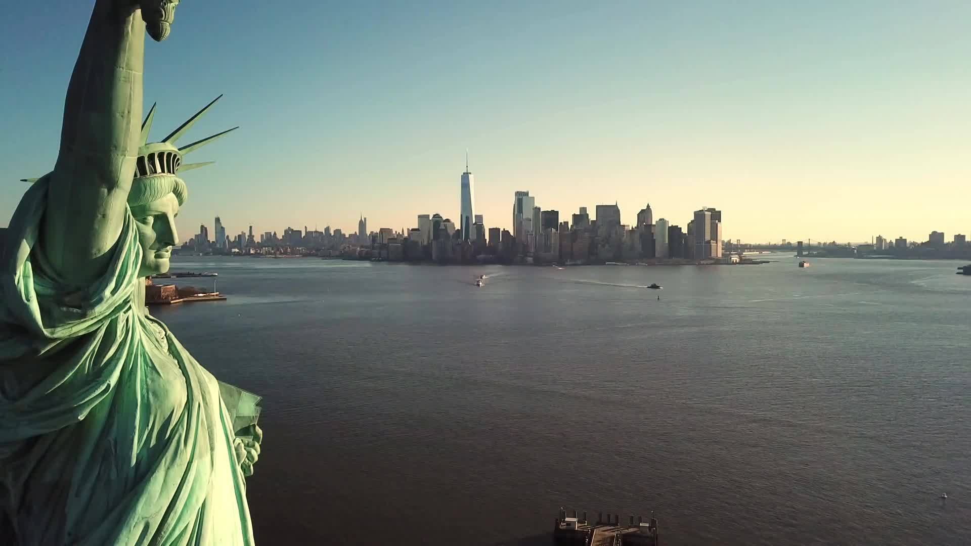 Statue of Liberty aerial pulling back daytime Manhattan skyline New York City NYC 4K and 1080 HD