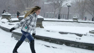 girl running in snow, blizzard in Washington Square Park snowing in winter storm slow motion 4K