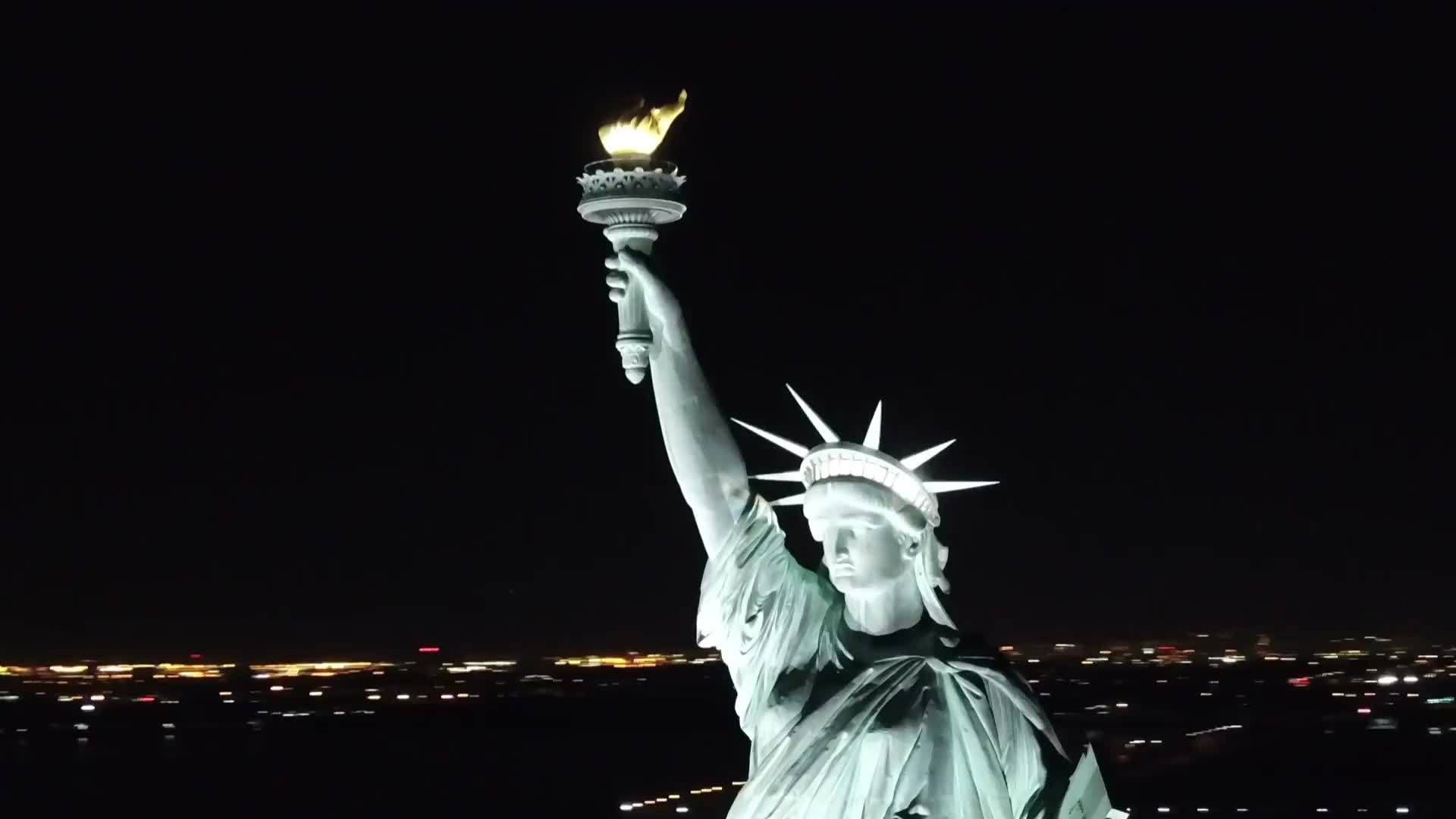 close up of Statue of Liberty aerial circling at night New York City NYC 1080 HD