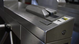 close-up of hand swiping Metro card in subway train station turnstile at 125th Street in Harlem