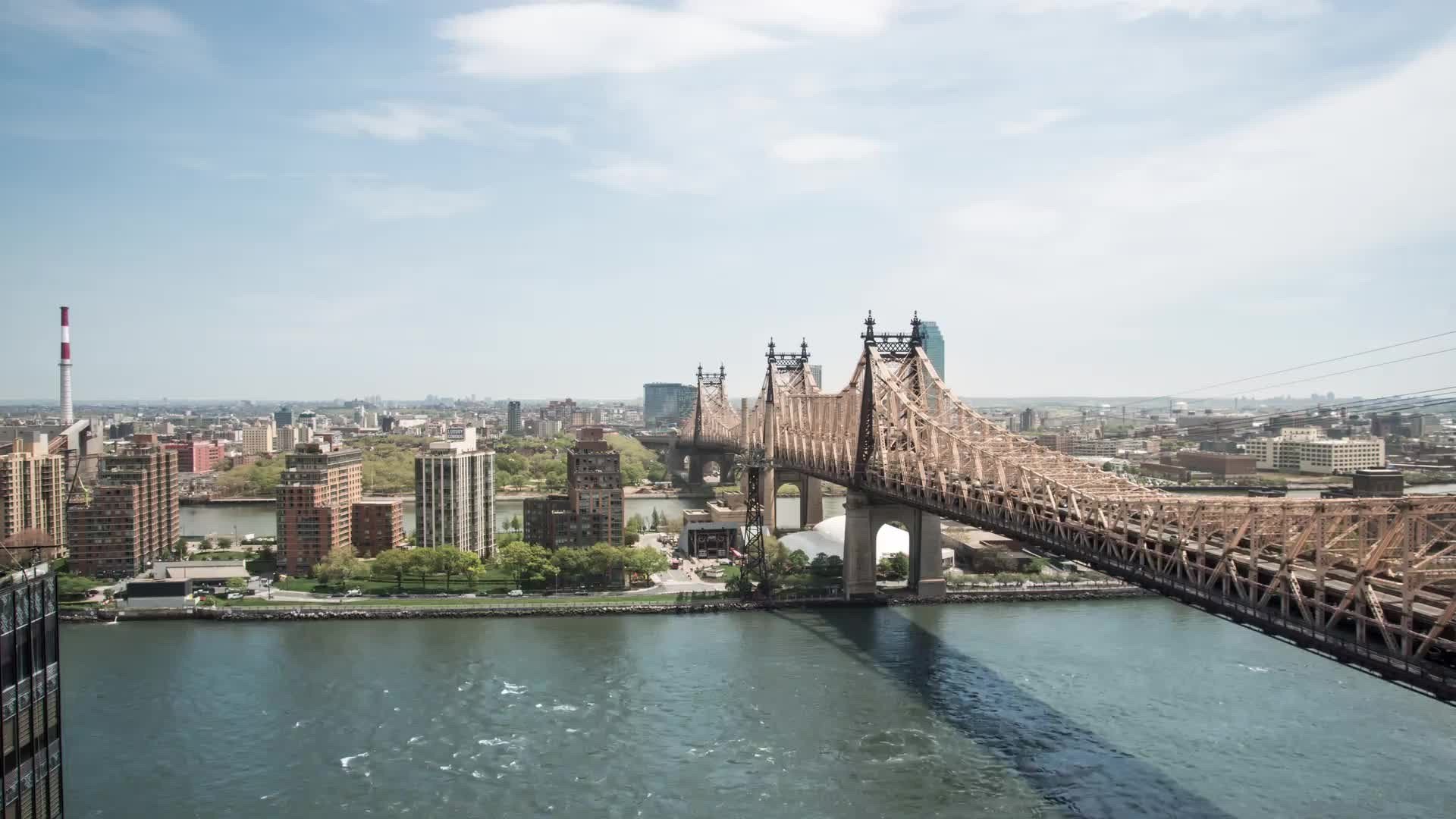 pushing in on Queensboro Bridge over East River in timelapse NYC