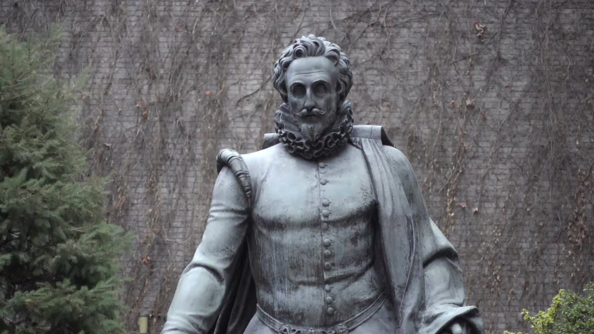 Miguel Cervantes statue at Washington Square and 5th Ave in NYU courtyard garden, down long walkway in NYC 1080