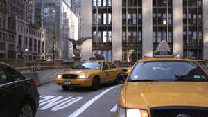 taxis driving - cabs turning through Park Ave underpass in MetLife Building in Midtown Manhattan