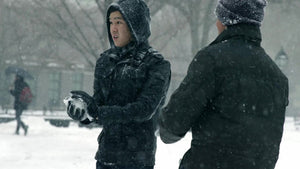 guys throwing snowballs in winter blizzard storm, snowing in Washington Square Park - Asian and Indian man throw snow ball in snowball fight slow motion 4K