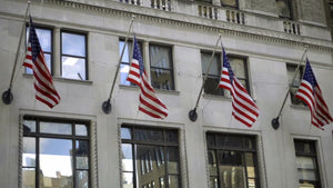 4 American flags waving on building in Midtown Manhattan in NYC