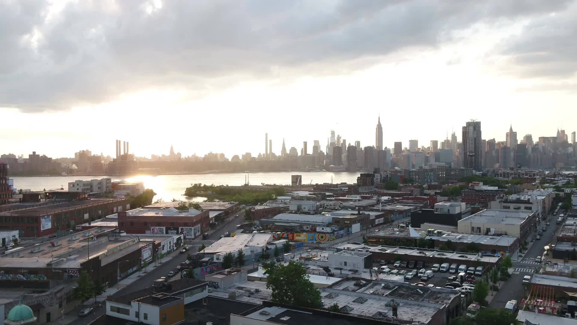 aerial over graffiti art in Greenpoint Brooklyn toward Manhattan skyline New York City NYC