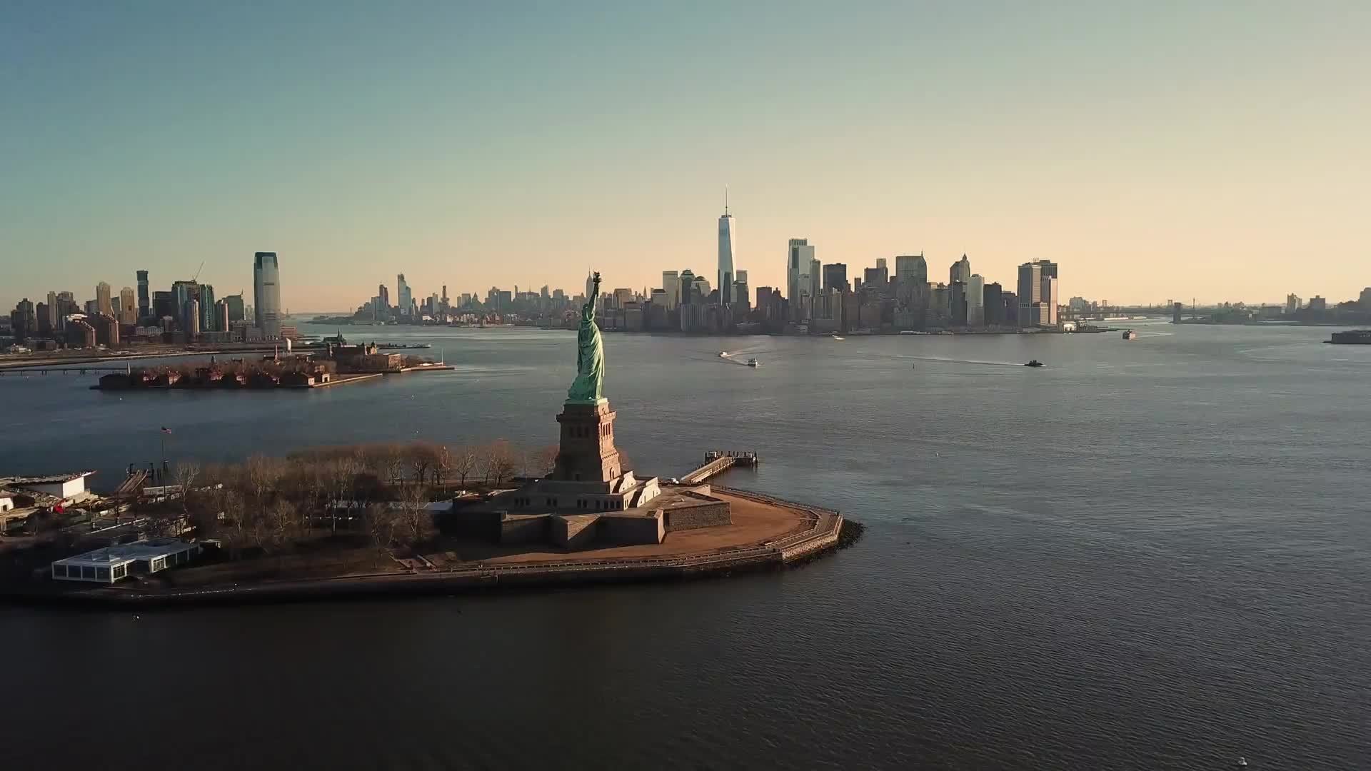 Statue of Liberty forward aerial toward Manhattan New York City skyline 4K and 1080 HD NYC