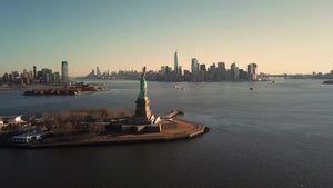 Statue of Liberty forward aerial toward Manhattan New York City skyline 4K and 1080 HD NYC
