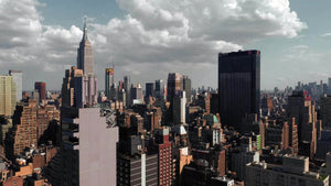 Midtown Manhattan skyscrapers from aerial view moving over buildings toward Empire State Building in New York City NYC